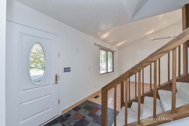 foyer featuring vaulted ceiling