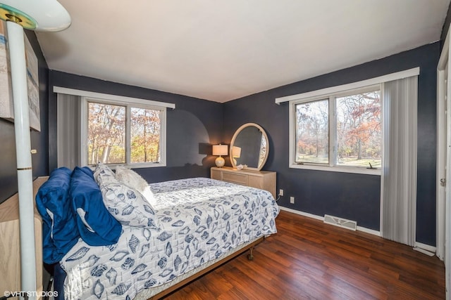 bedroom with dark wood-type flooring