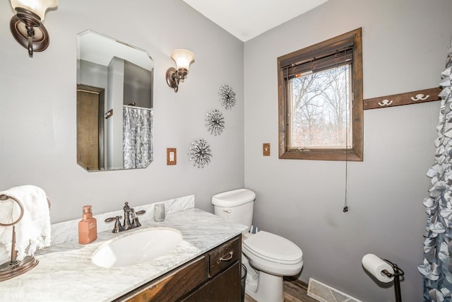 bathroom featuring vanity and toilet