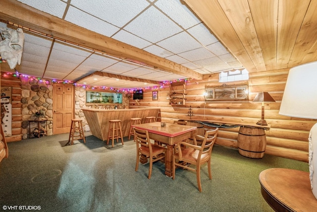 dining room with log walls, carpet floors, and indoor bar