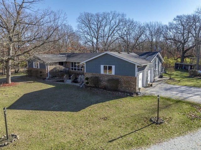 ranch-style home with a front yard and a garage