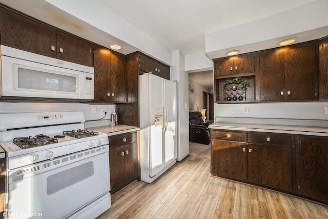 kitchen with white appliances, light hardwood / wood-style floors, and dark brown cabinetry