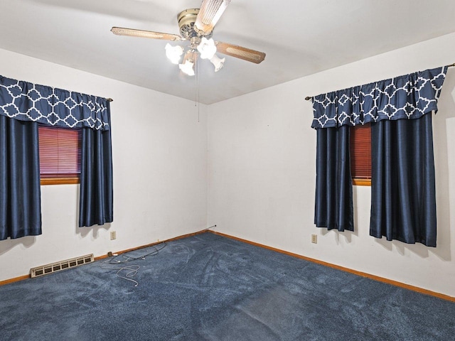 spare room with carpet and ceiling fan