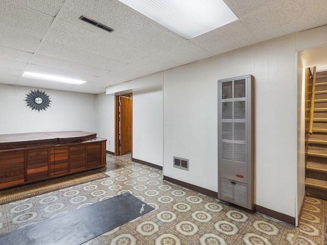 interior space with a paneled ceiling