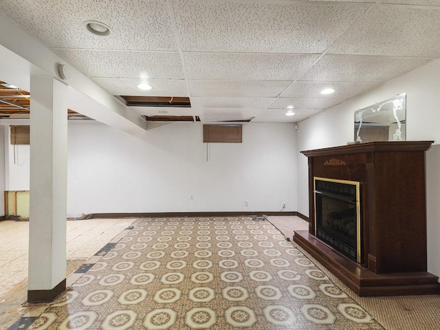 basement featuring a paneled ceiling