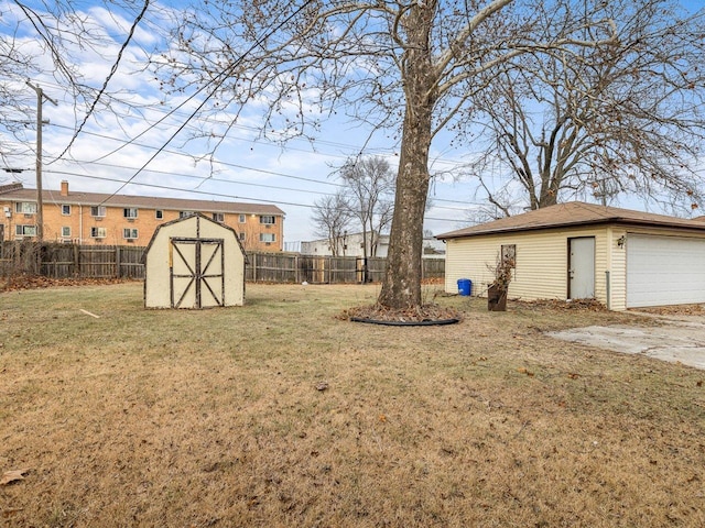 view of yard with a garage and a storage unit