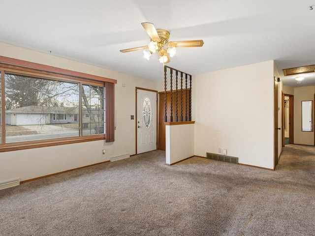 spare room with ceiling fan and carpet