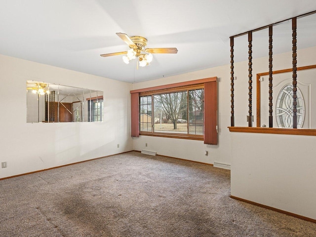 carpeted spare room featuring ceiling fan