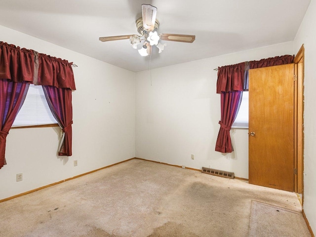 unfurnished room featuring ceiling fan and carpet