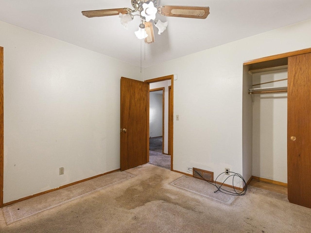 unfurnished bedroom featuring carpet flooring, ceiling fan, and a closet