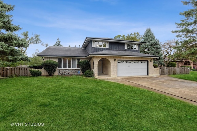 view of front of house featuring a front yard and a garage