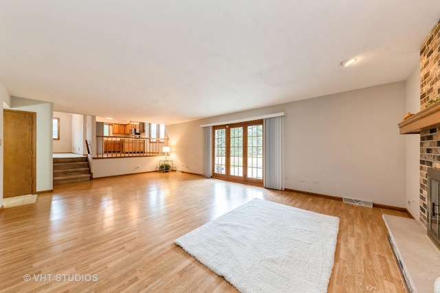 unfurnished living room with a fireplace and light hardwood / wood-style flooring