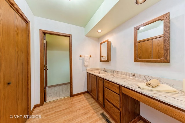 bathroom featuring hardwood / wood-style flooring and vanity