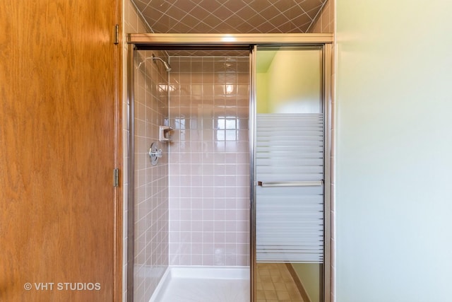 bathroom with a shower with shower door