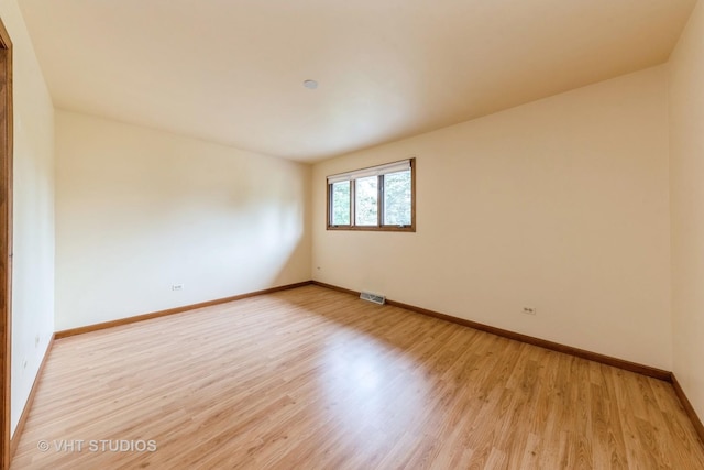 empty room with light hardwood / wood-style flooring