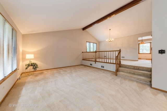 carpeted living room with lofted ceiling with beams, plenty of natural light, and a notable chandelier