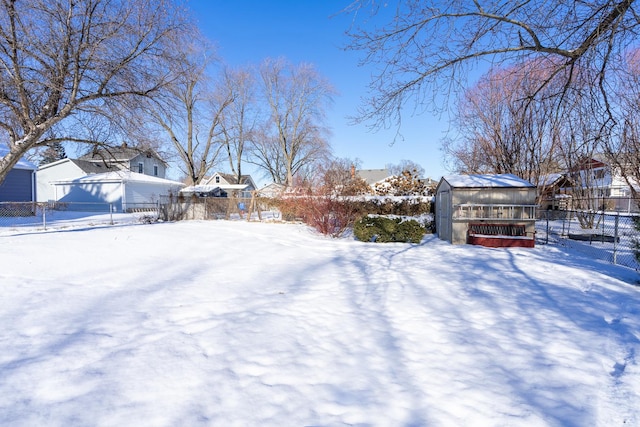 snowy yard with an outbuilding