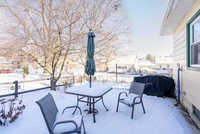 snow covered patio featuring area for grilling