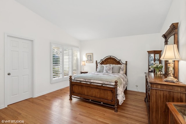 bedroom featuring light hardwood / wood-style flooring and vaulted ceiling