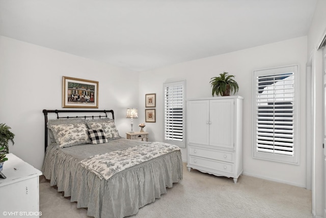 bedroom featuring light colored carpet