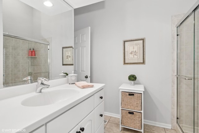 bathroom featuring vanity, tile patterned floors, and walk in shower