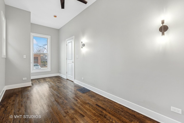 spare room featuring ceiling fan and dark hardwood / wood-style flooring