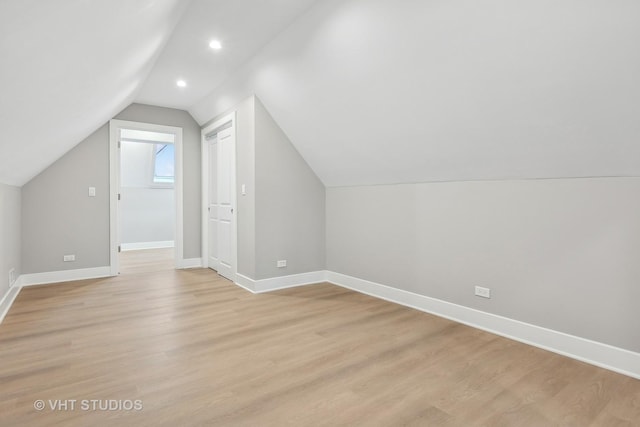 additional living space with lofted ceiling and light wood-type flooring