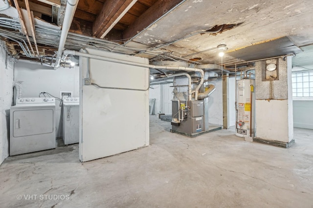 basement featuring gas water heater, heating unit, and washing machine and clothes dryer