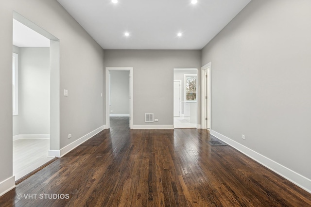 empty room with dark hardwood / wood-style floors