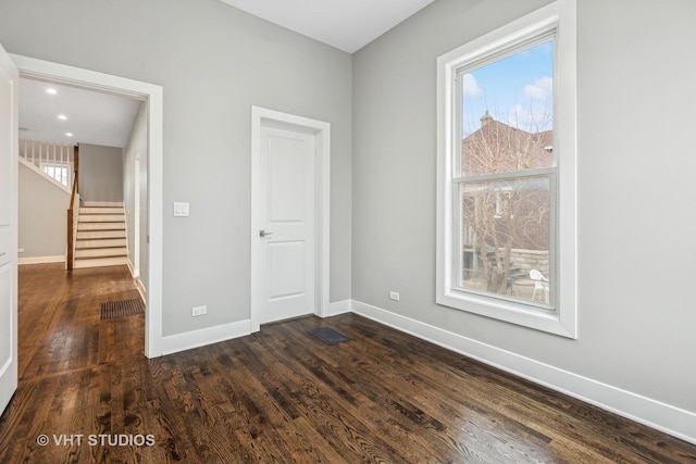 spare room featuring dark hardwood / wood-style floors