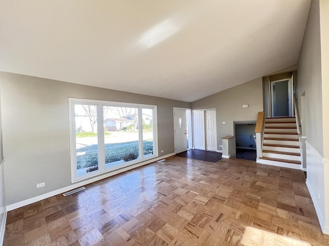 interior space featuring light parquet flooring and lofted ceiling