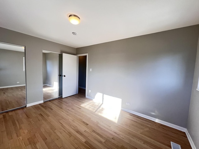 unfurnished bedroom featuring hardwood / wood-style flooring