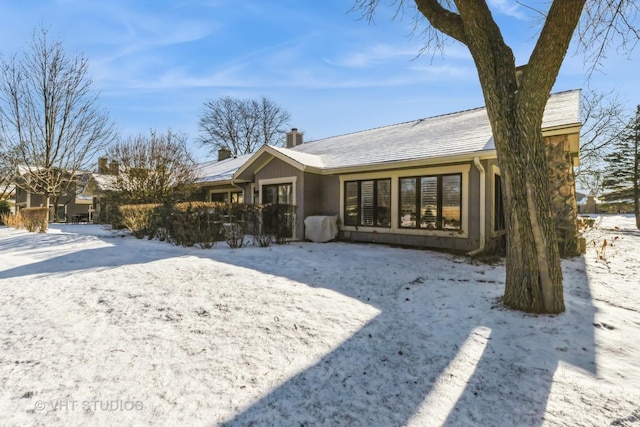 view of snow covered rear of property