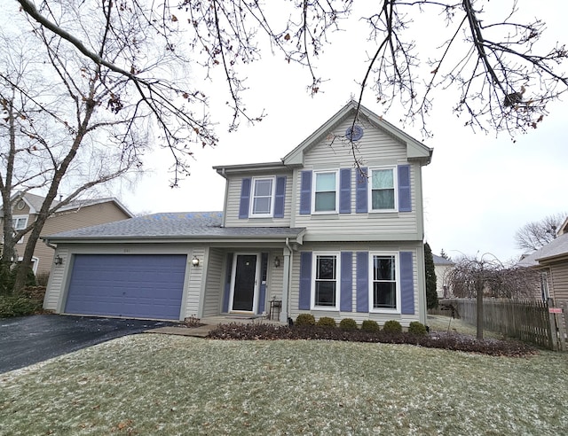 front facade with a front lawn and a garage