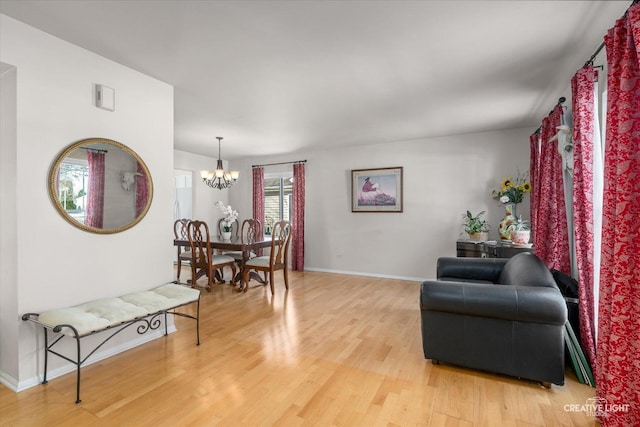 sitting room featuring hardwood / wood-style flooring and a notable chandelier