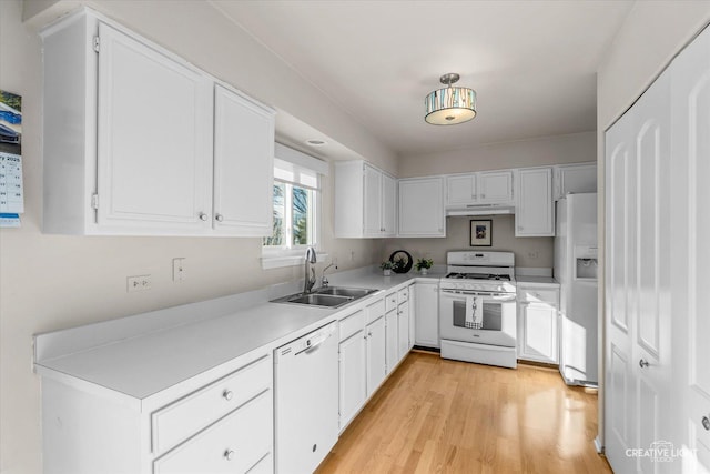 kitchen featuring white appliances, white cabinetry, light hardwood / wood-style flooring, and sink