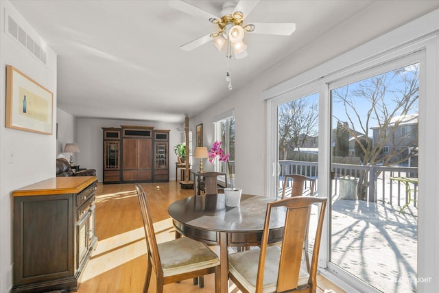 dining room with ceiling fan and light wood-type flooring