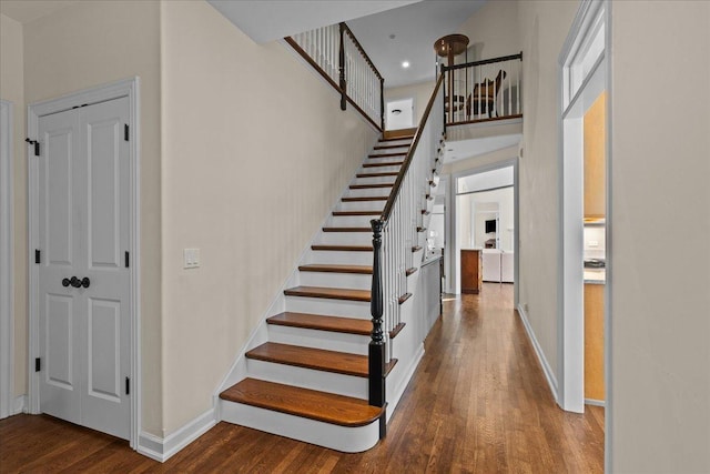 stairs featuring hardwood / wood-style flooring