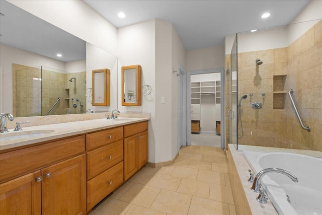 bathroom with tile patterned flooring, vanity, and independent shower and bath