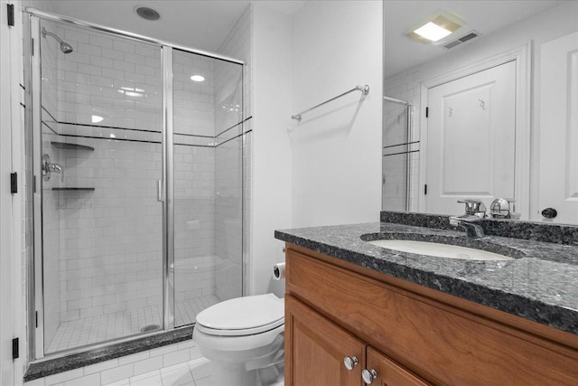 bathroom with vanity, tile patterned flooring, toilet, and walk in shower