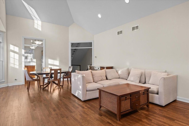 living room featuring dark hardwood / wood-style floors and high vaulted ceiling