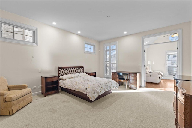 carpeted bedroom featuring multiple windows