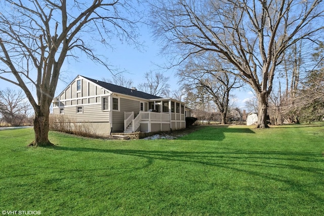 view of side of property with a lawn and a sunroom