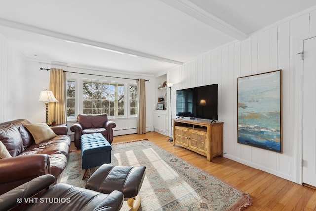 living room with beam ceiling, ornamental molding, a baseboard heating unit, and light wood-type flooring