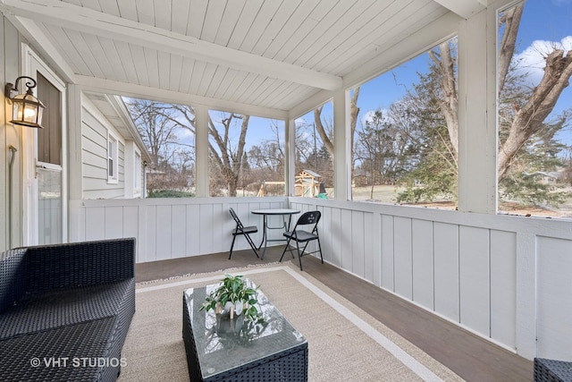 sunroom with beam ceiling