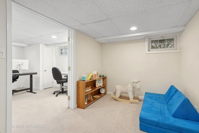 carpeted home office featuring a paneled ceiling