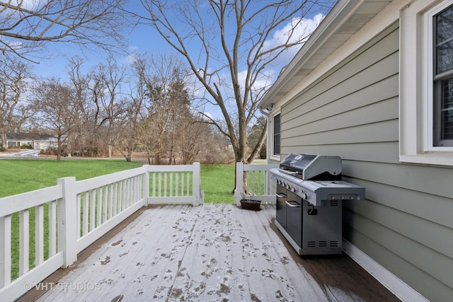 wooden deck featuring a yard and area for grilling