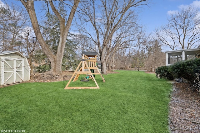 view of yard with a playground, a sunroom, and a storage unit