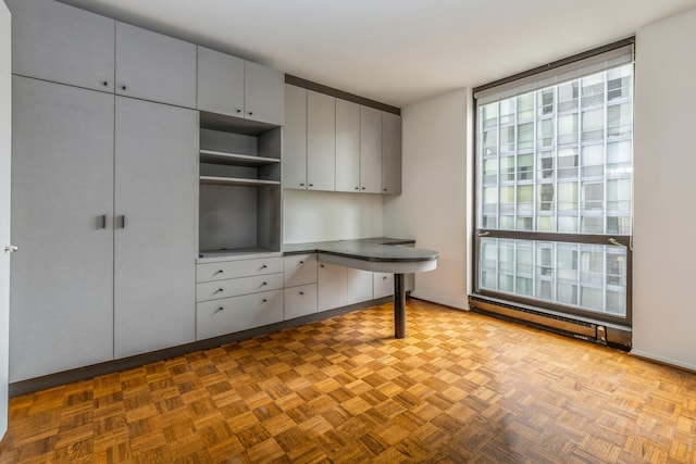 unfurnished office featuring light parquet flooring