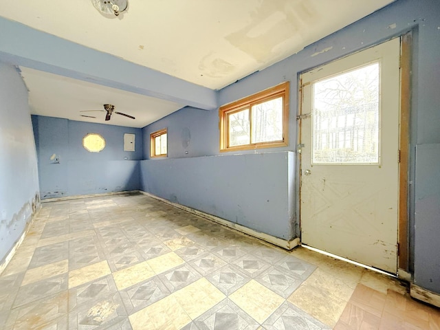 empty room featuring ceiling fan and beam ceiling